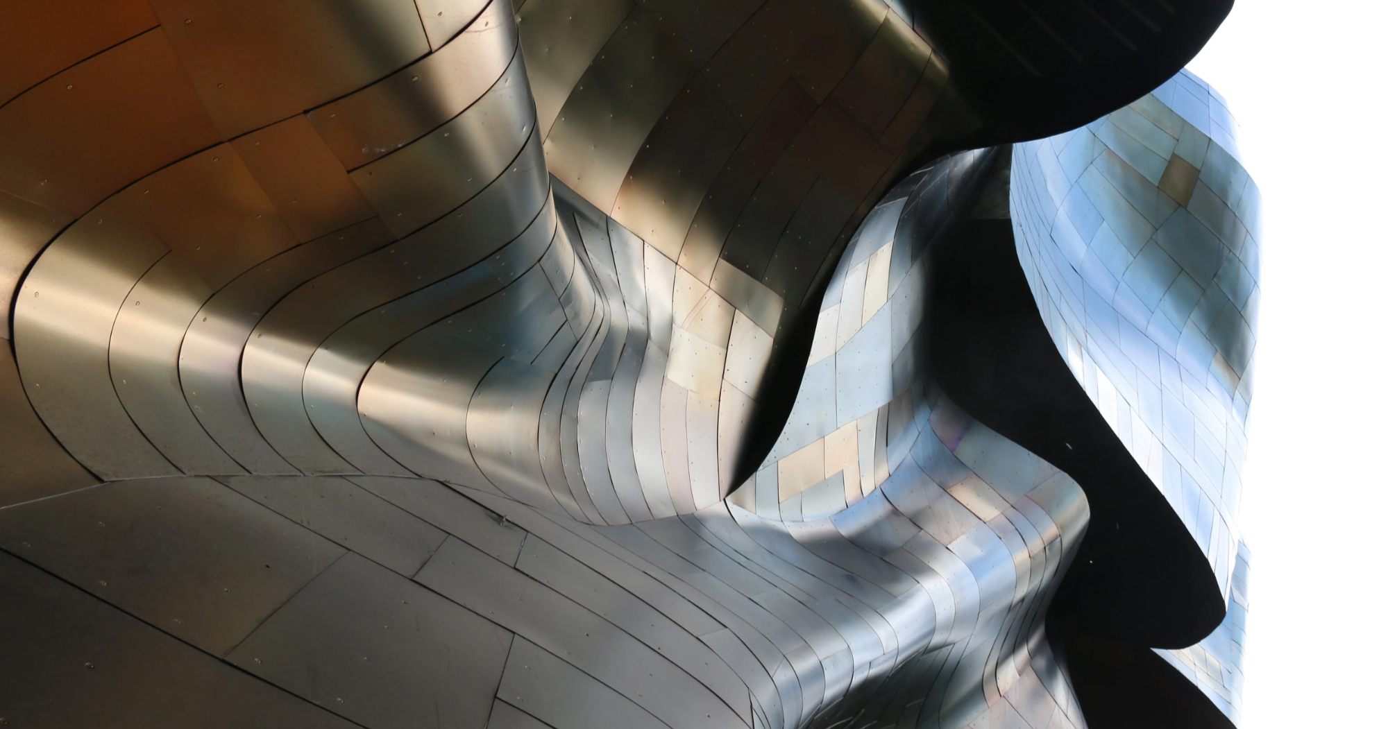 The curved surface of the facade of the Museum of Pop Culture in Seattle.